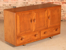 Load image into Gallery viewer, A mid century Ercol Windsor elm sideboard on casters, circa 1960s