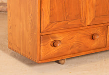 Load image into Gallery viewer, A mid century Ercol Windsor elm sideboard on casters, circa 1960s