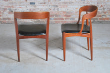 Load image into Gallery viewer, Set of 4 Danish Mid Century Model 16 teak dining chairs with original black vinyl upholstery by Johannes Andersen for Uldum Mobelfabrik, circa 1960s.