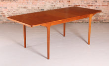 Load image into Gallery viewer, Mid Century extending teak dining table by McIntosh, circa 1960s.&nbsp;
