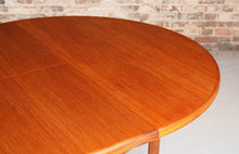 Load image into Gallery viewer, Mid Century round extending teak dining table by McIntosh, circa 1970s
