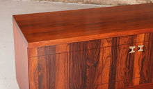 Load image into Gallery viewer, A pair of Mid Century rosewood low sideboards with hinged brass handles by Troeds, Sweden, circa 1970s
