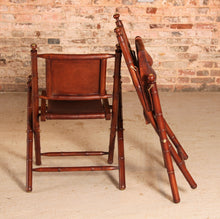 Load image into Gallery viewer, Contemporary campaign style teak, leather and brass folding chairs by Eichholtz
