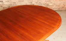 Load image into Gallery viewer, Danish Mid Century teak extending round dining table by Edvard Valentinsen, circa 1960s.
