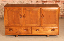 Load image into Gallery viewer, A mid century Ercol Windsor elm sideboard on casters, circa 1960s
