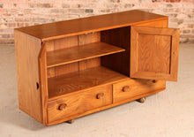 Load image into Gallery viewer, A mid century Ercol Windsor elm sideboard on casters, circa 1960s
