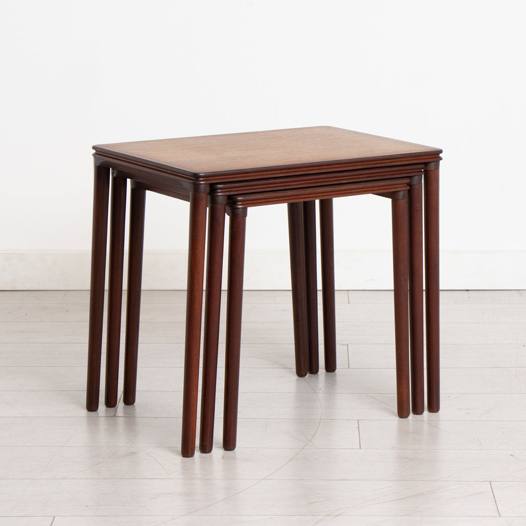 A Danish midcentury nest of three side tables made in teak and rosewood by E W Bach. Excellent restored condition.