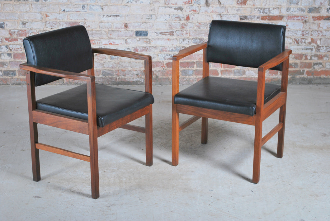 A pair of Mid Century ex-MOD teak and vinyl armchairs, circa 1960s.