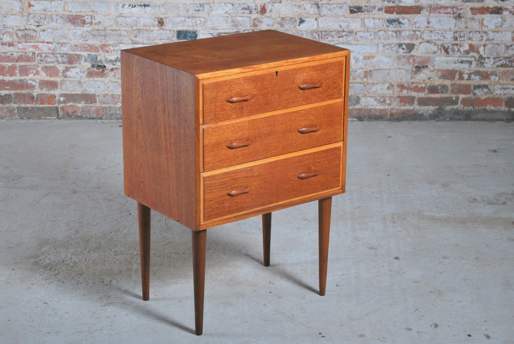 Mid Century teak chest of 3 drawers on tapered legs, circa 1960s