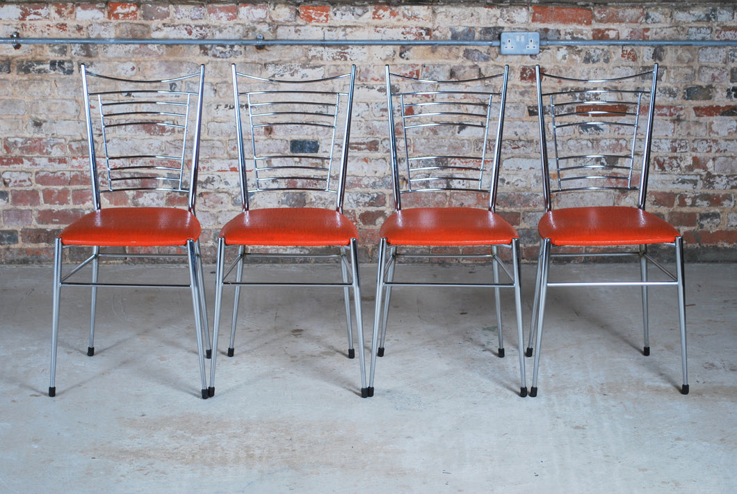 Set of 4 Mid Century chrome and vinyl dining chairs with original red upholstery.