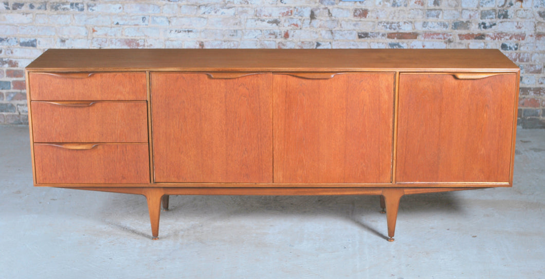 A Mid Century Dunvegan teak sideboard designed by Tom Robertson and manufactured by A.H. McIntosh of Kirkcaldy, Scotland, circa 1960s.