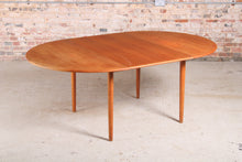 Load image into Gallery viewer, Danish Mid Century round extending teak dining table, circa 1960s.
