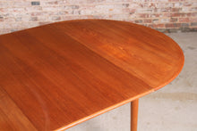 Load image into Gallery viewer, Danish Mid Century round extending teak dining table, circa 1960s.
