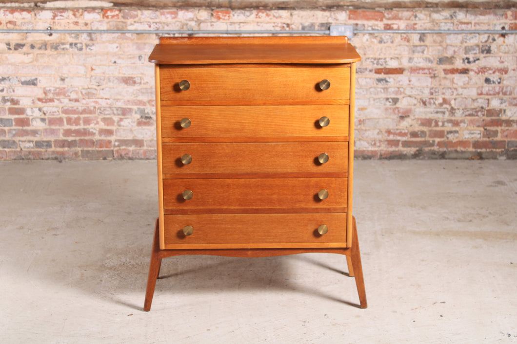 Mid Century teak chest of 5 drawers with a curved top and splayed legs, circa 1960s.
