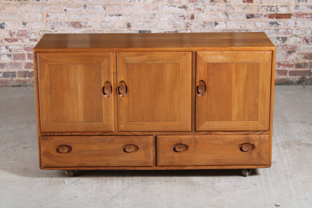 Mid Century Ercol Windsor elm sideboard on casters, c. 1960s