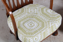 Load image into Gallery viewer, A pair of Arts &amp; Crafts nursing chairs with newly reupholstered cushions, circa 1930s.
