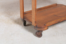 Load image into Gallery viewer, Art Deco style solid oak serving trolley on original brass casters.
