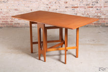 Load image into Gallery viewer, Mid Century drop-leaf teak dining table, circa 1960s.
