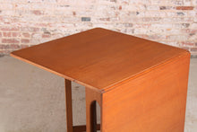 Load image into Gallery viewer, Mid Century drop-leaf teak dining table, circa 1960s.
