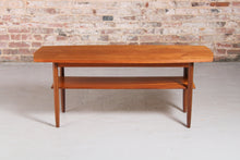 Load image into Gallery viewer, Mid Century teak coffee table with a magazine rack, circa 1960s
