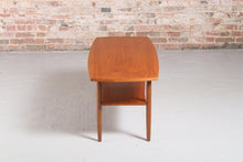 Load image into Gallery viewer, Mid Century teak coffee table with a magazine rack, circa 1960s
