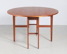 Load image into Gallery viewer, Mid Century drop-leaf teak dining table, circa 1960s.
