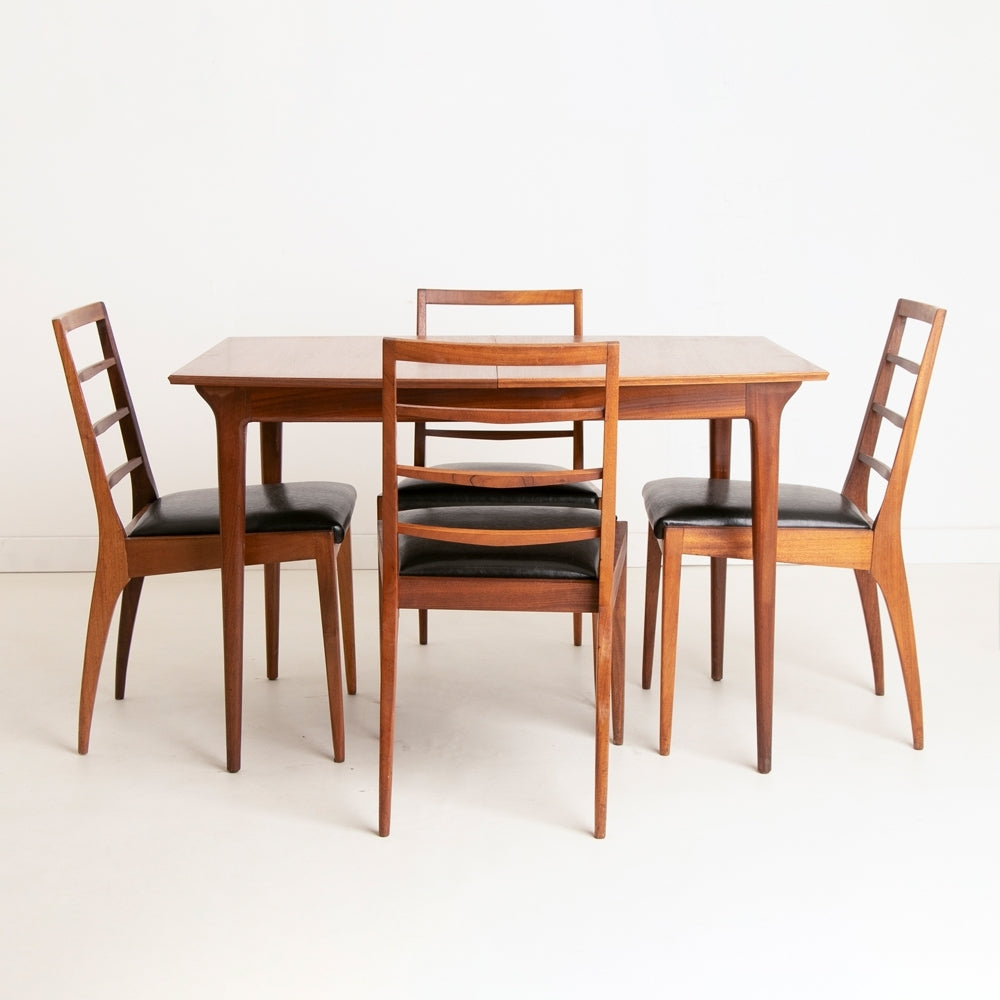 A British Mid Century teak extending dining table and four chairs designed by McIntosh, Scotland circa 1960s.